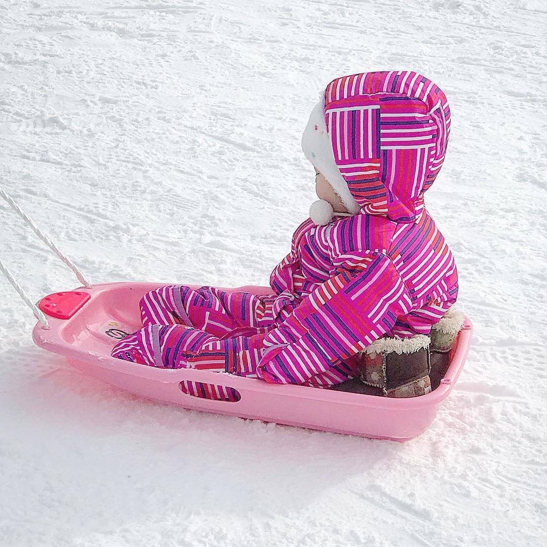 Pink sled and child