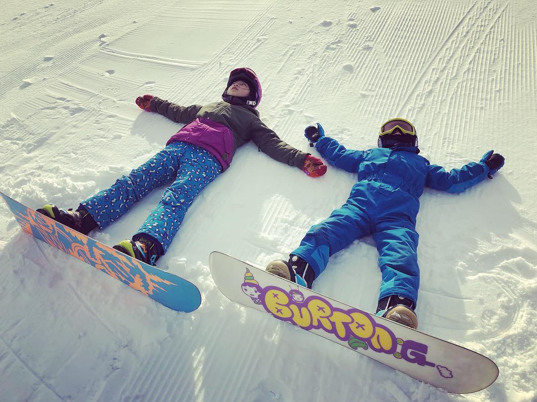 Children enjoying snow boarding in Iwanai