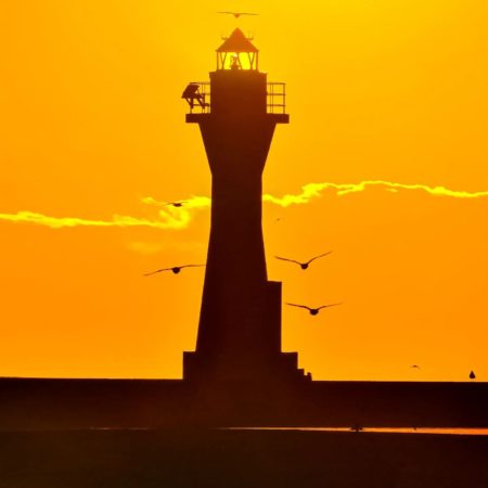 Lighthouse dyed in sunset